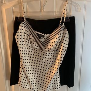 Black skirt and polka dot top.